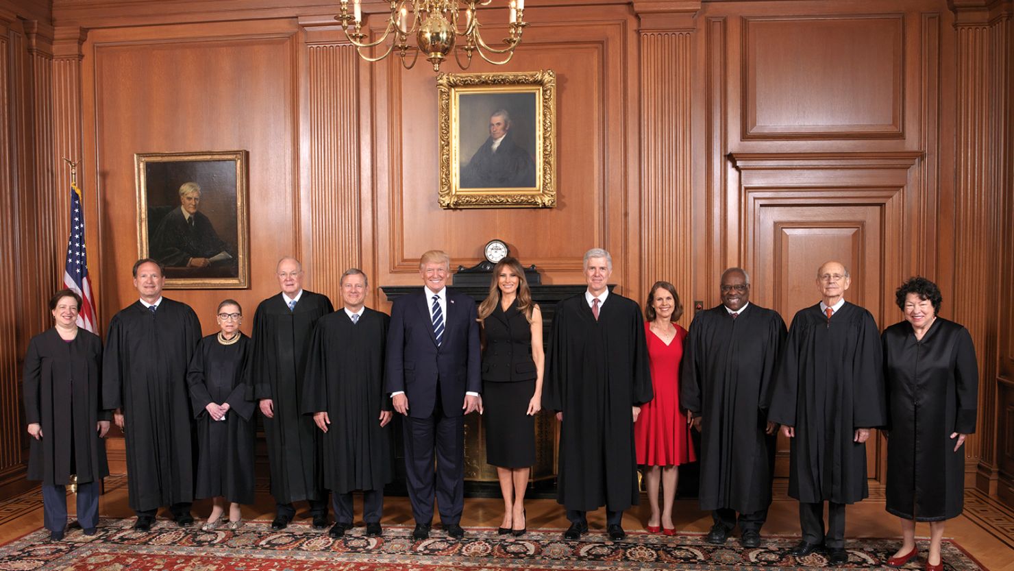 Donald Trump and Melania Trump standing alongside U.S. Supreme Court justices during a formal event.