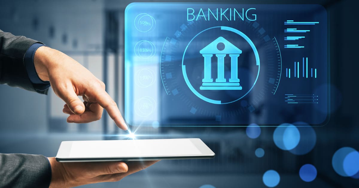A hand pointing at a tablet screen with a glowing hologram that displays the word “Banking” above it.