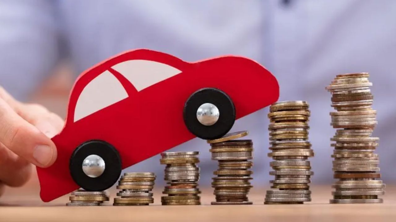 A toy car climbing a growing pile of coins, symbolizing the rising costs of car loans and vehicle financing in the United States.