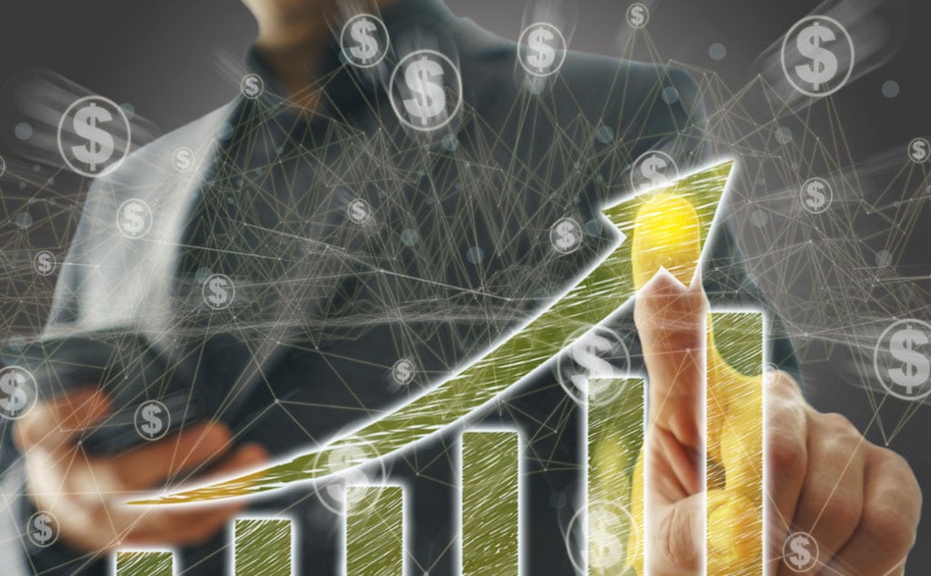 A businessman swiping an upward-trending money graph, symbolizing business growth and financial success.