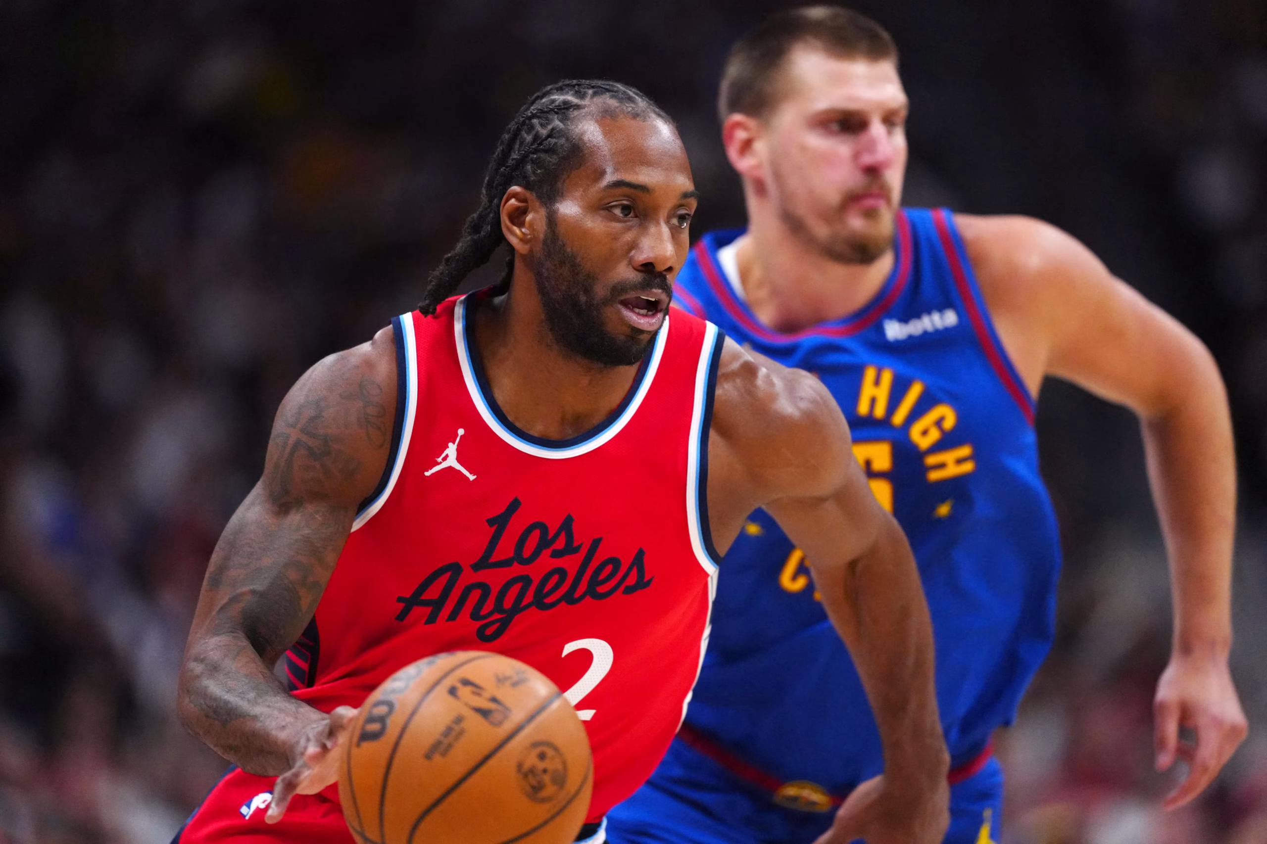 Kawhi Leonard in a Clippers uniform, dribbling the basketball during an NBA game.