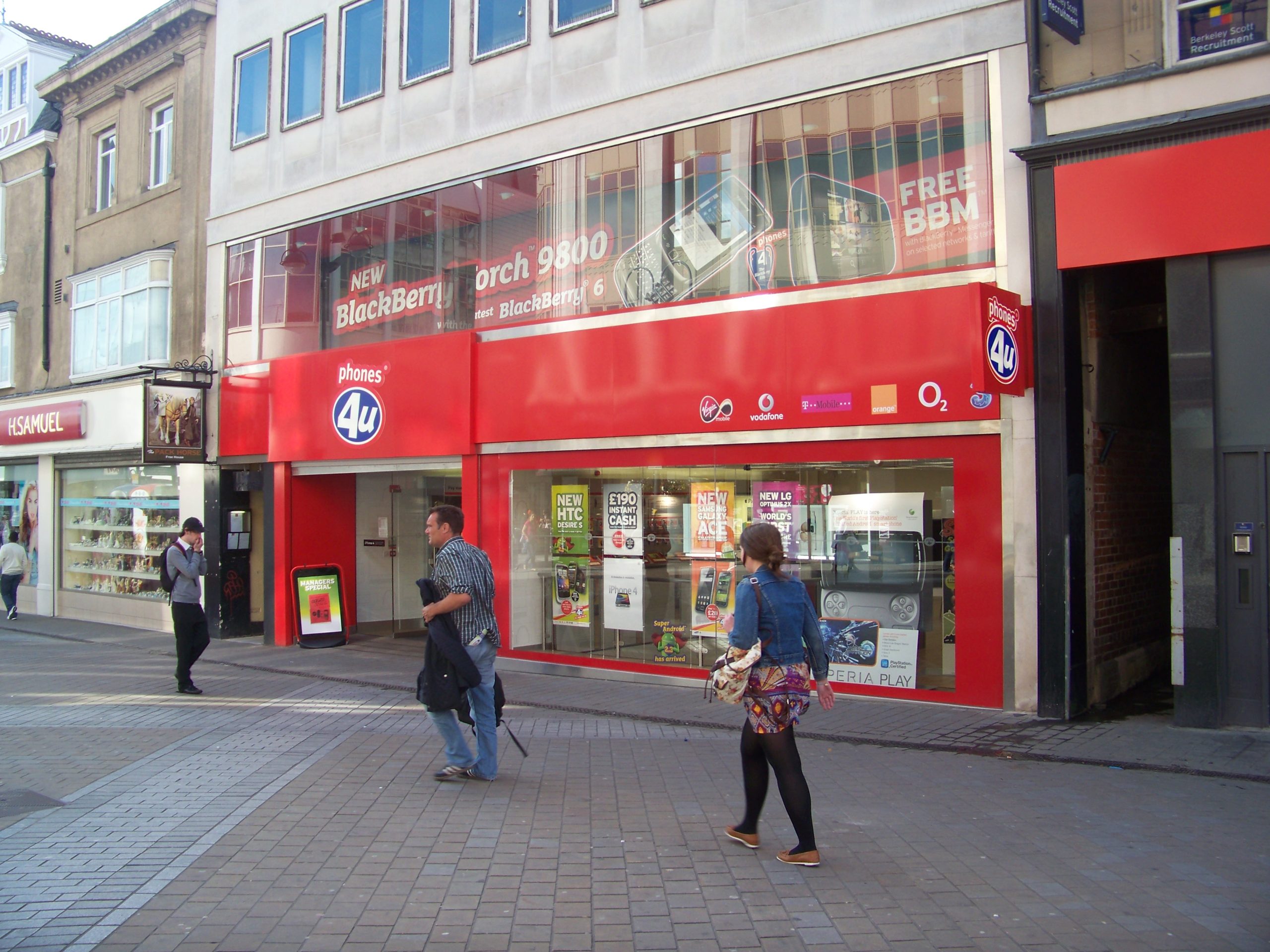 Exterior view of a Phones 4u retail store with branding visible on the storefront.