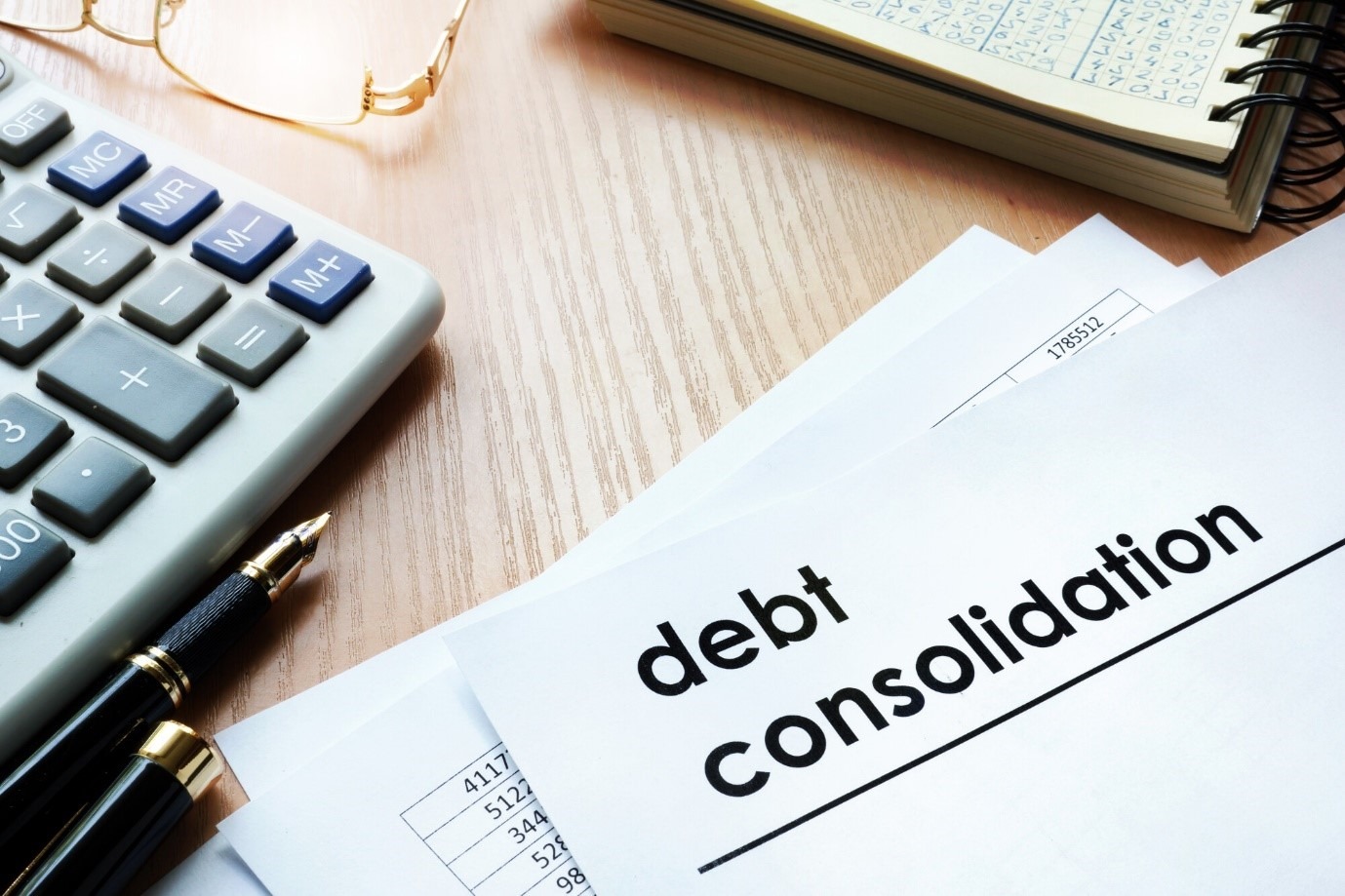 A stack of paperwork and documents labeled “Debt Consolidation,” representing financial planning and loan management.