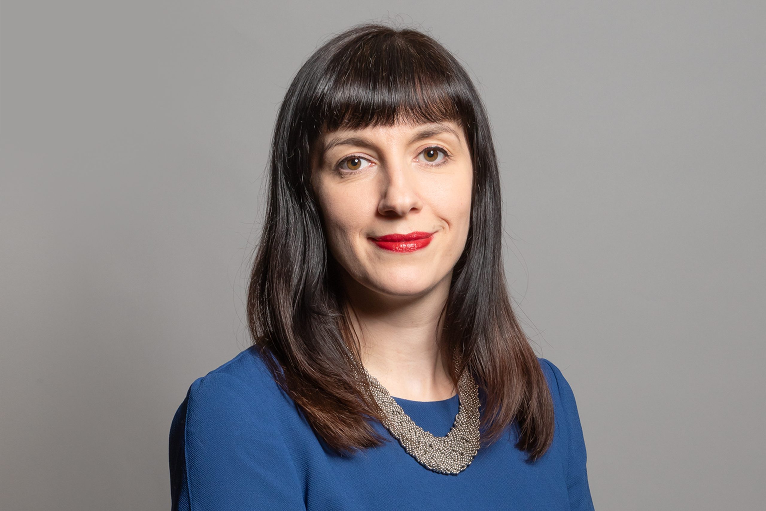 Professional headshot of Bridget Phillipson, UK Education Secretary, wearing a navy blazer and smiling confidently.