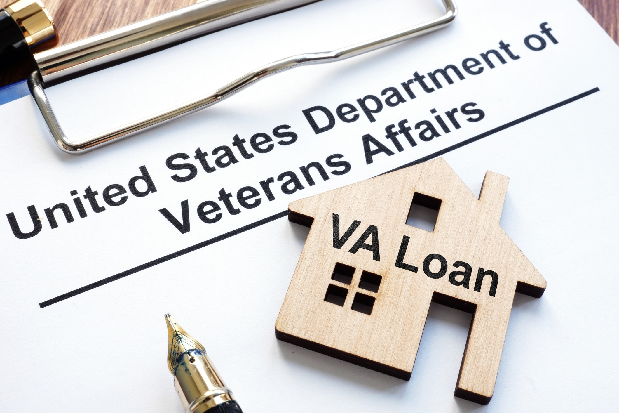 U.S. Department of Veterans Affairs document with a wooden house block labeled “VA Loan.”