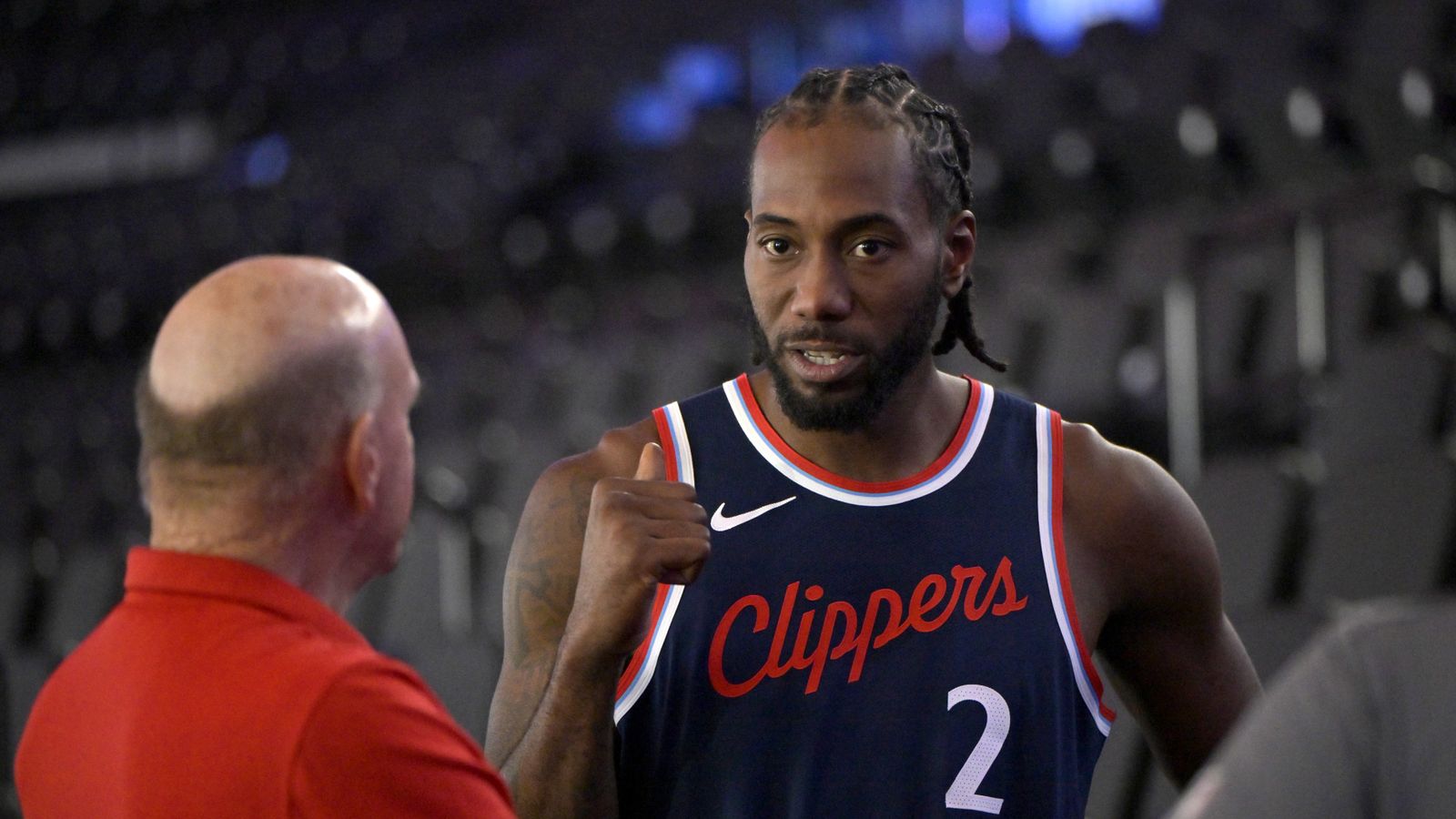 Kawhi Leonard gesturing toward Clippers owner Steve Ballmer during a game on the sidelines.