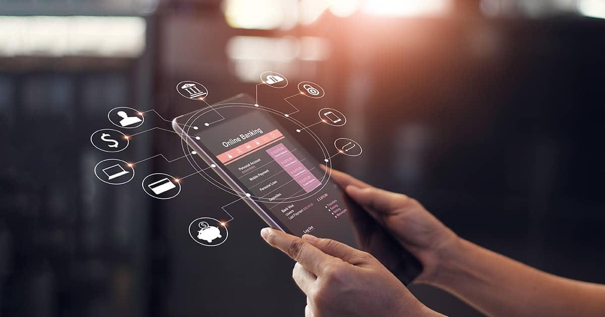 A person holding a smartphone with multiple digital banking icons floating above the screen.