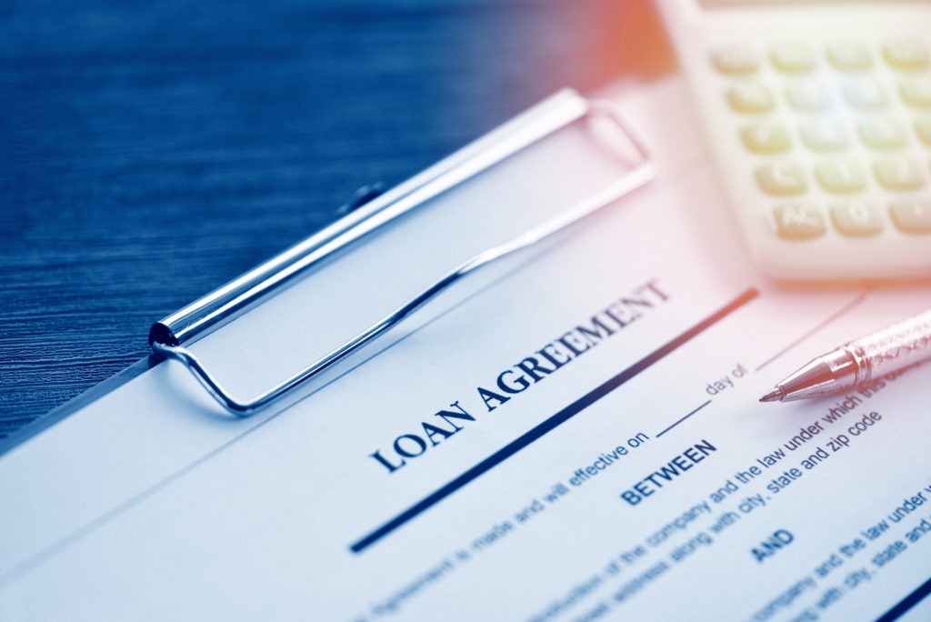 Close-up of a loan agreement document with pen ready for signing