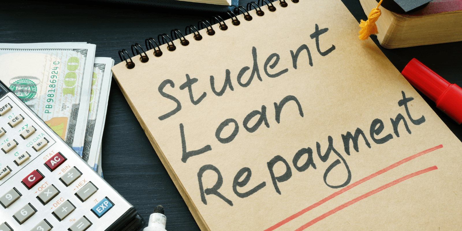 A pile of cash placed beneath a calculator and a notebook labeled “Student Loan Repayment,” representing budgeting and debt management.