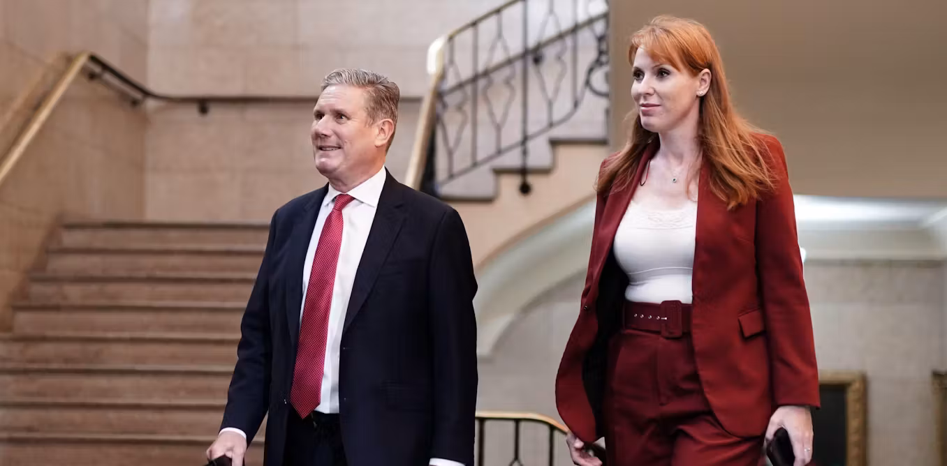 Angela Rayner and Sir Keir Starmer walking side by side in formal attire during a public appearance.