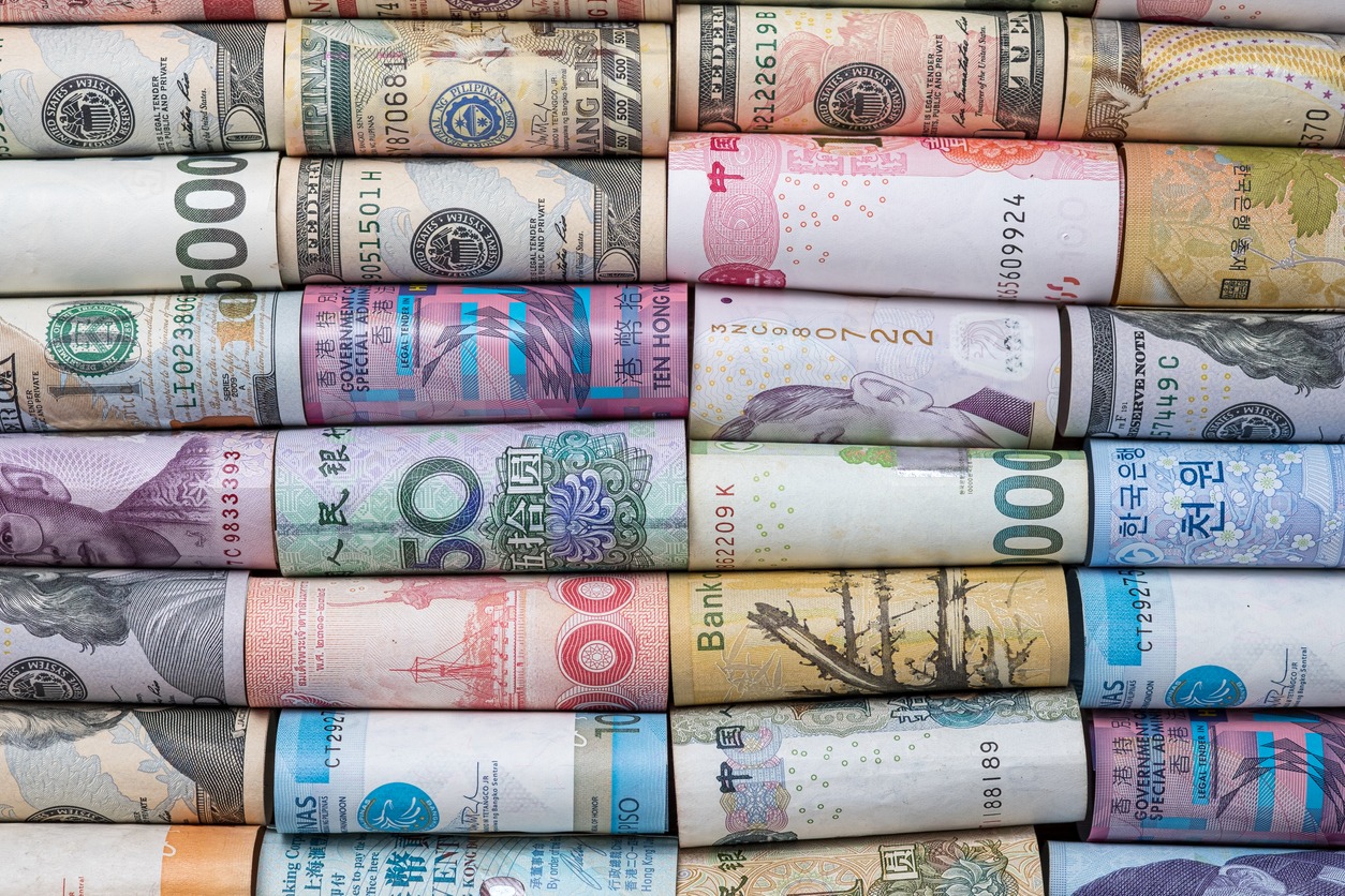 closeup rolled of variety banknote and multi currency around the world. exchange rate and forex investment concept. image.