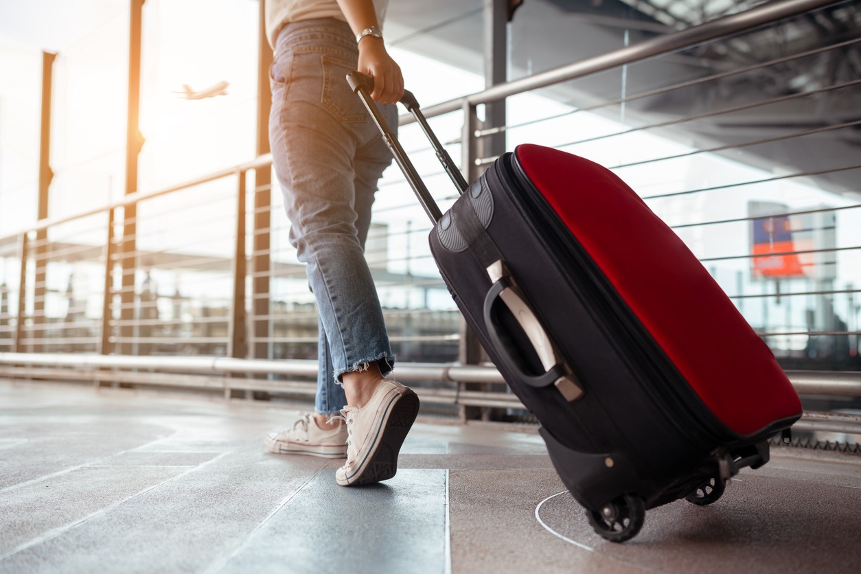 traveler with suitcase in airport concept.young girl walking with carrying luggage and passenger for tour travel booking ticket flight at international vacation time in holiday rest and relaxation.