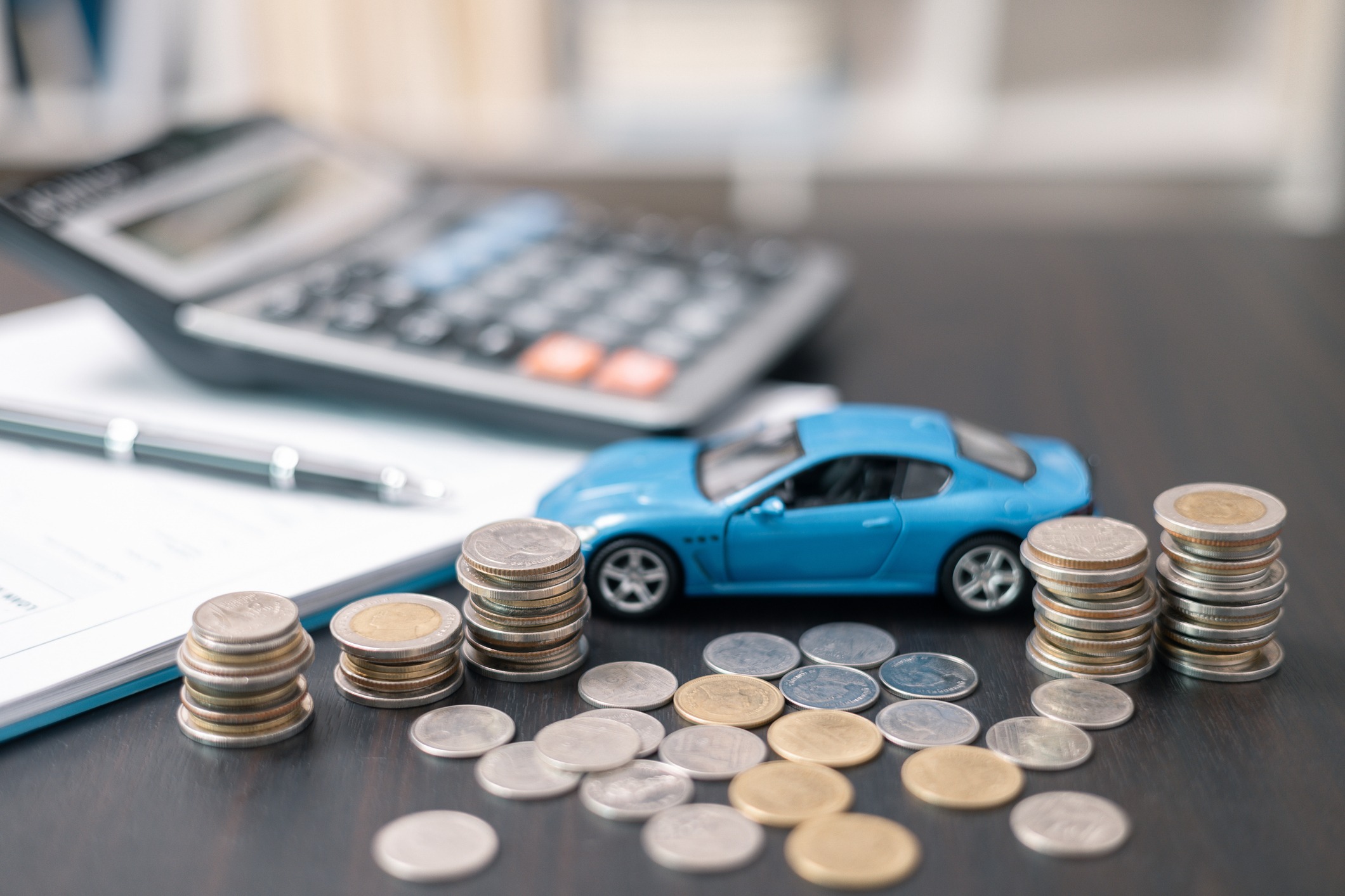business concept involved using finance calculator to determine premium for vehicle policy, ensuring clear financial contract for car. investing in auto insurance can save money on transport costs.