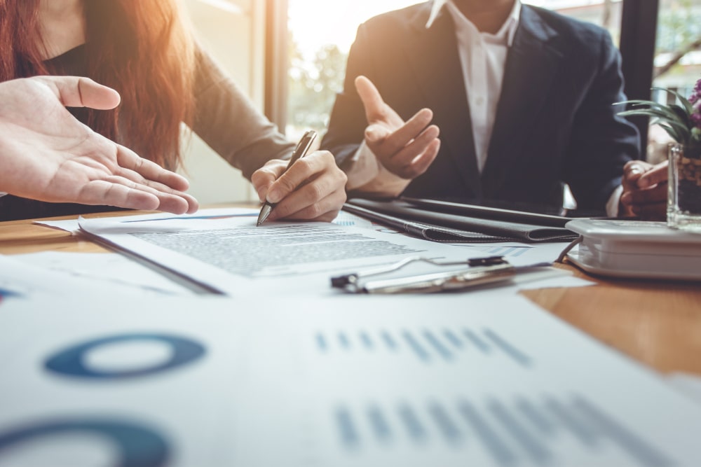 Business professionals in a meeting negotiating contract terms around a table