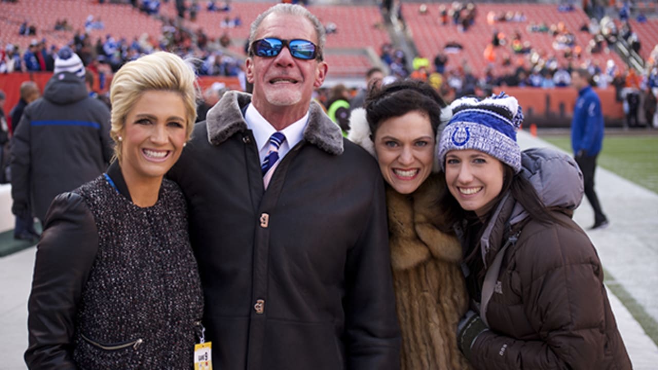 Jim Irsay poses with his daughters—Carlie Irsay-Gordon, Casey Foyt, and Kalen Jackson—at an Indianapolis Colts game, smiling for the camera.
