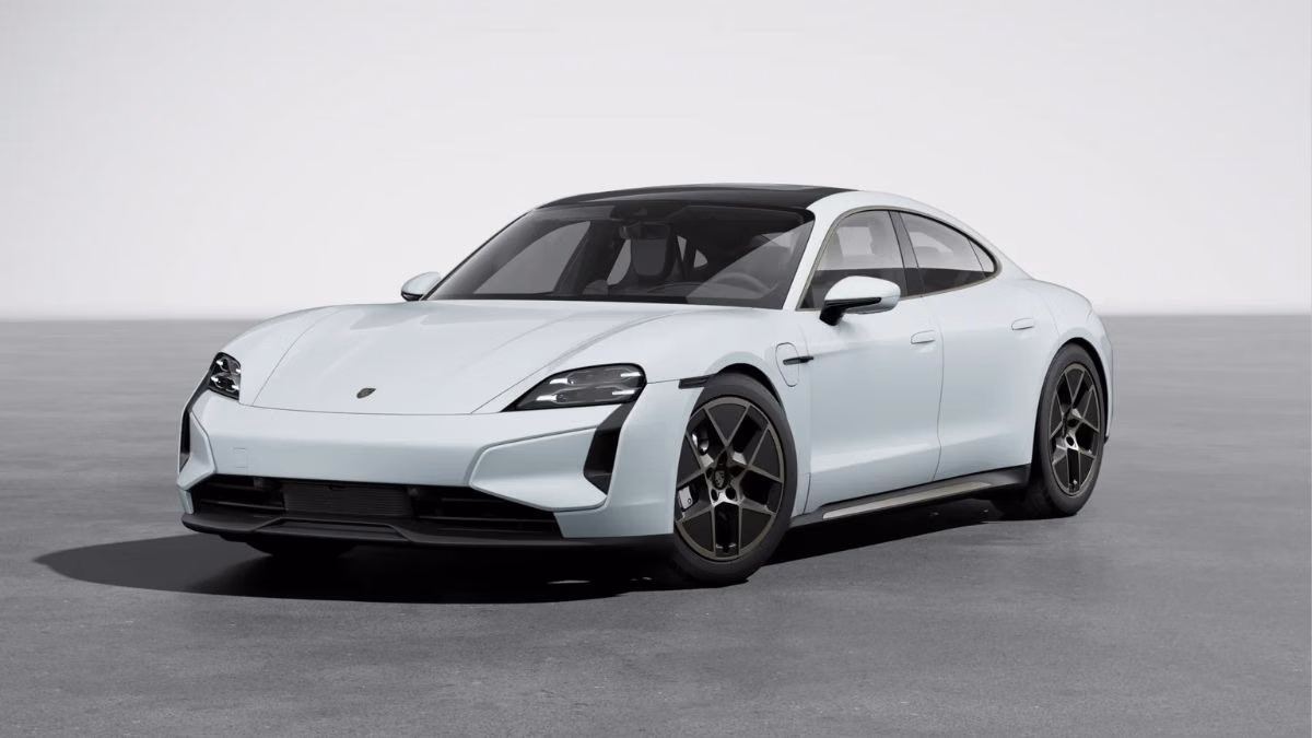 A white Porsche Taycan Turbo, the flagship electric model in Porsche’s EV lineup, parked with sleek styling and modern design.