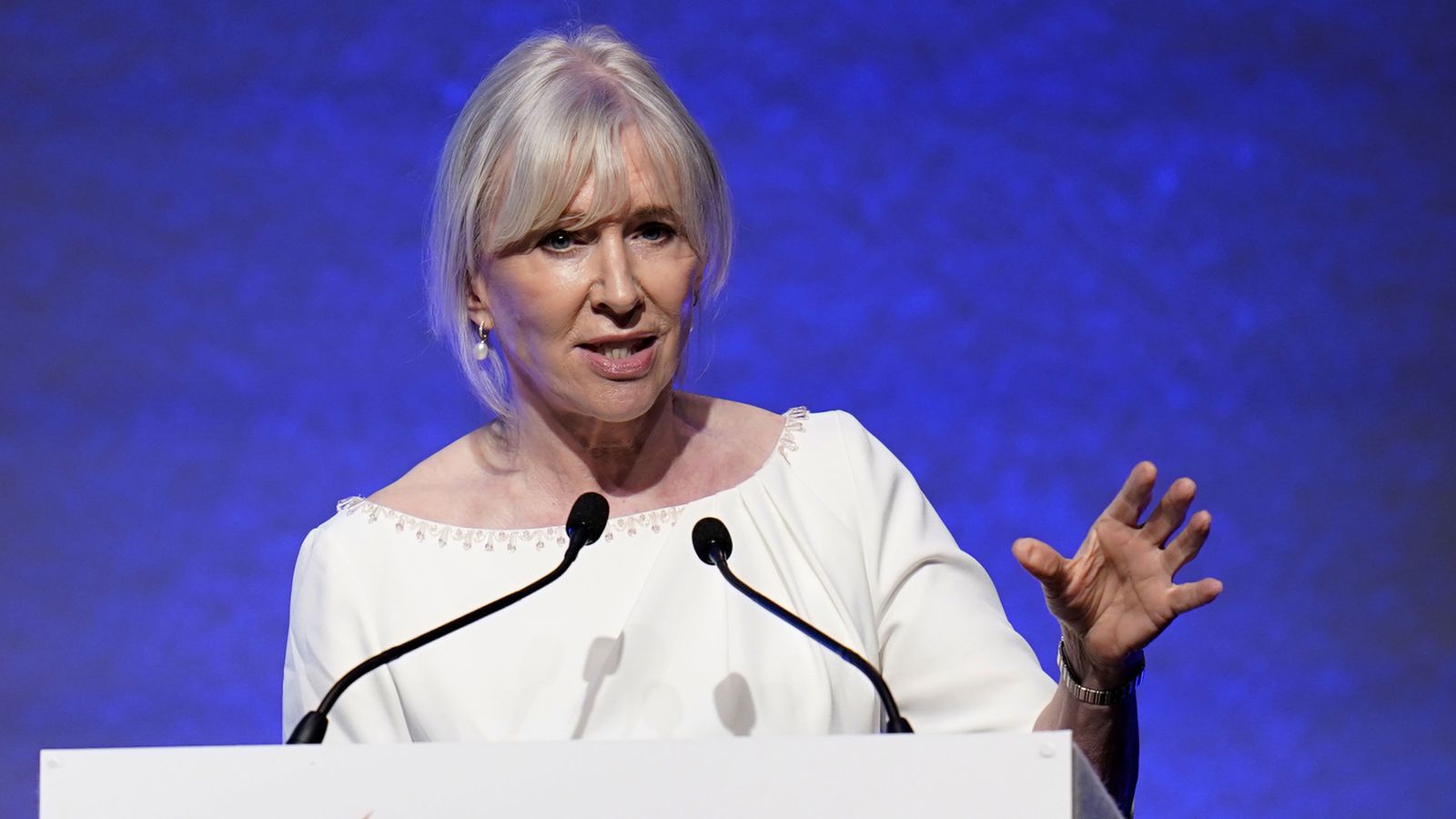 Nadine Dorries speaking passionately at a podium during a political event, addressing an audience.