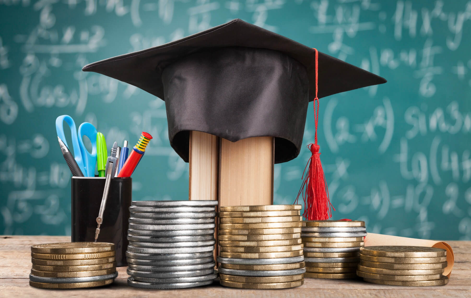 A graduation cap in a classroom surrounded by money and teaching materials, symbolizing the financial challenges of education and student loans.