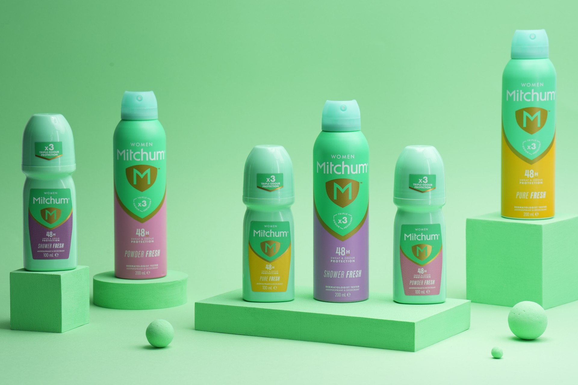 A lineup of Mitchum deodorant bottles showing different roll-on variants and scents.