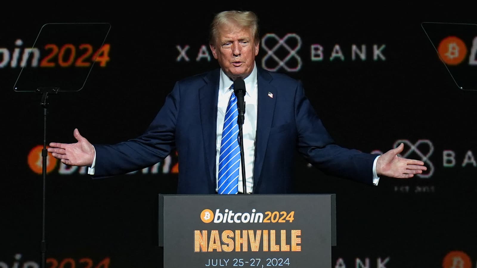 Donald Trump speaking at a cryptocurrency and Bitcoin conference, gesturing while addressing the audience.