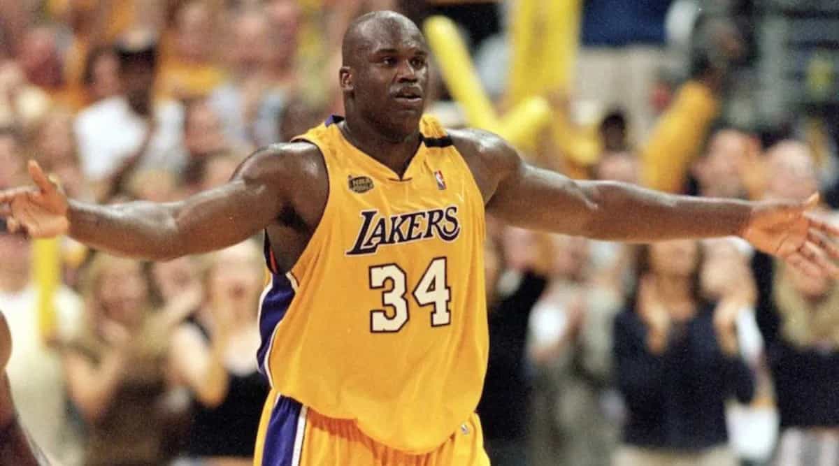 Shaquille O’Neal in action on the basketball court wearing a Los Angeles Lakers uniform.