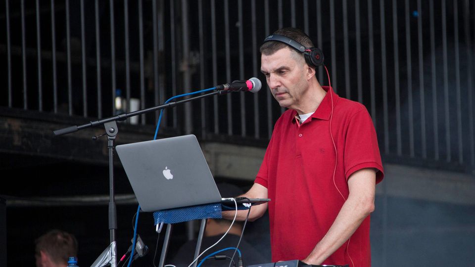 Tim Westwood performing a live DJ set on stage, engaging the crowd with music and energy.