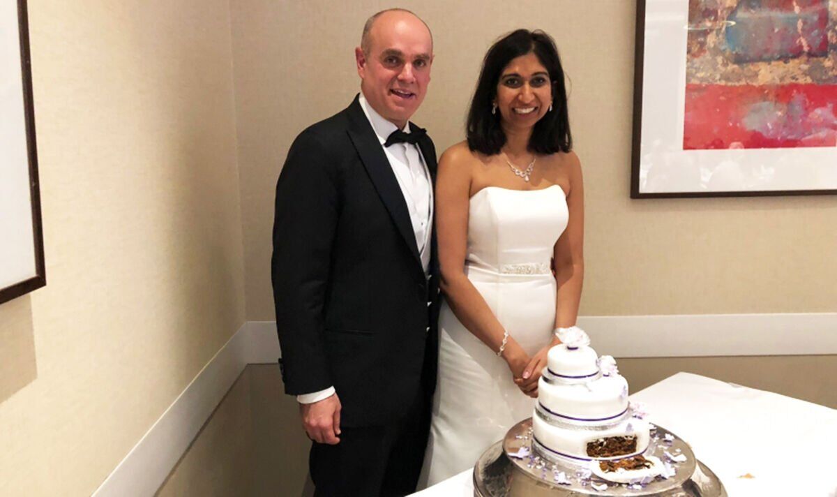 Suella Braverman and her husband cutting their wedding cake.