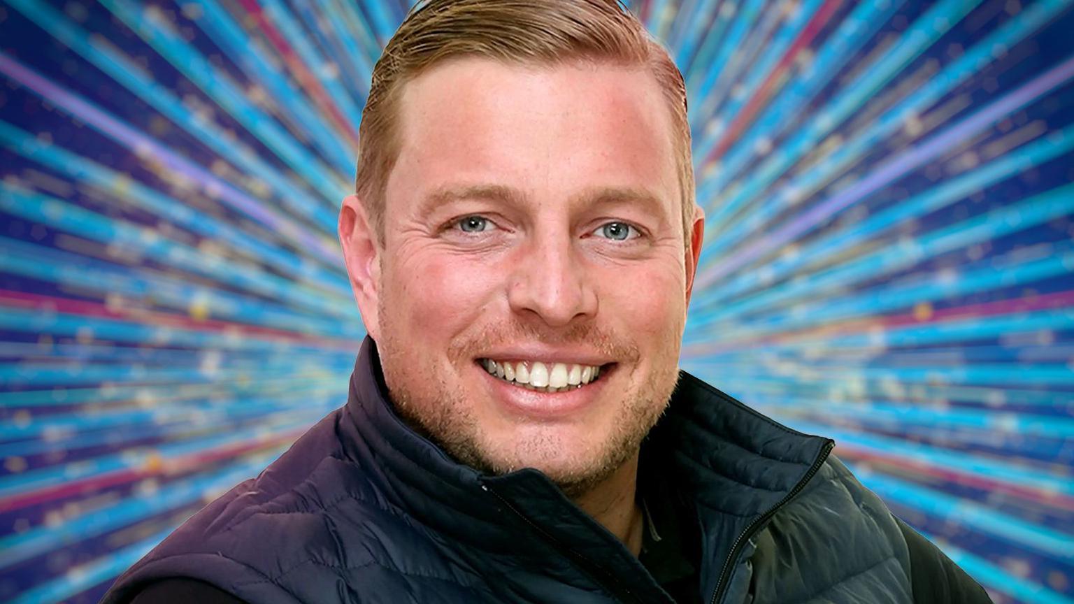 Tom Skinner posing confidently on the Strictly Come Dancing 2025 promotional poster, dressed in a stylish suit and smiling at the camera.