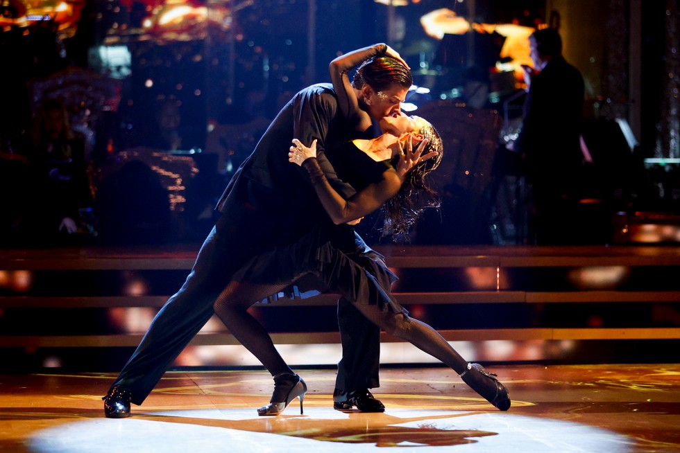 Nikita Kuzmin and Amber Davies sharing a kiss during their Strictly Come Dancing performance, sparking speculation about the Strictly curse.