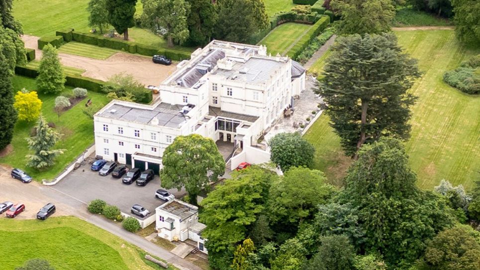 Aerial view of Royal Lodge, Windsor, showing the expansive 30-room mansion and surrounding grounds.