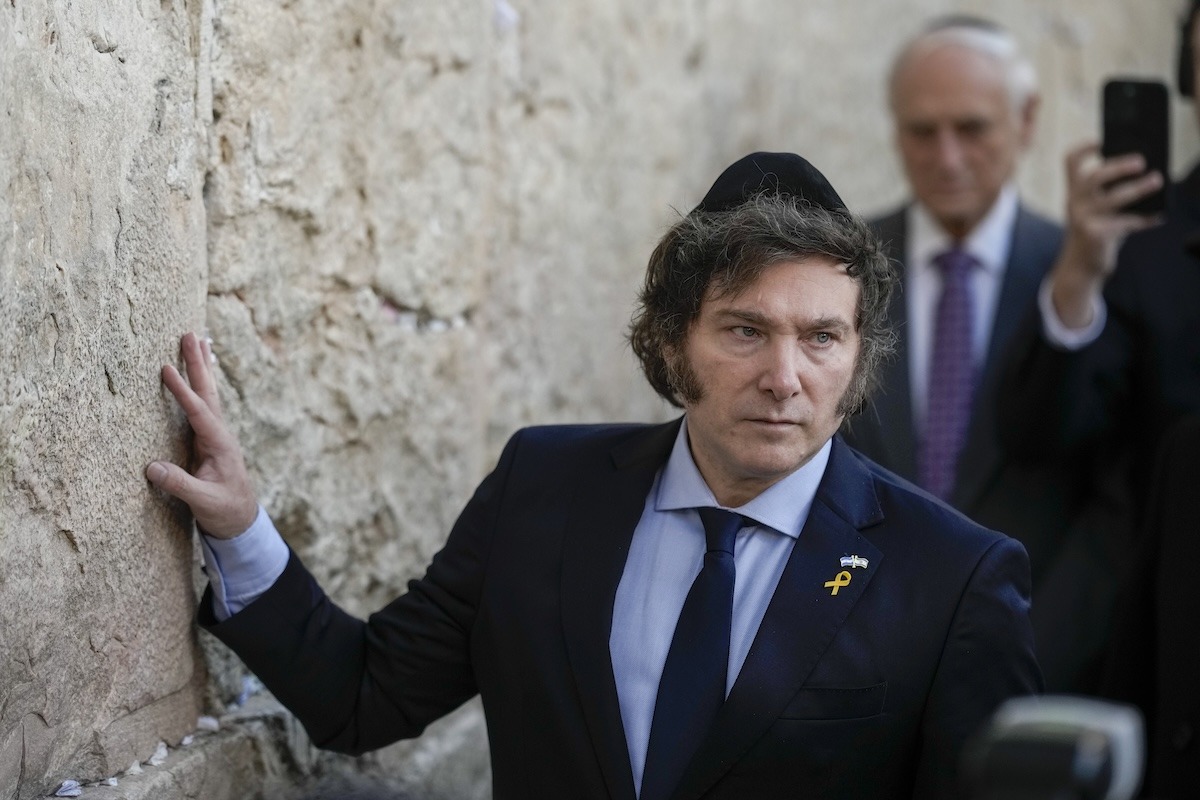 Argentine President Javier Milei placing his hand on the Western Wall in Jerusalem’s Old City, a sacred site for Jewish prayer.