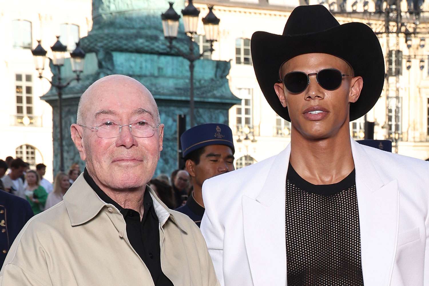 David Geffen and David Armstrong standing together in Trafalgar Square, London, posing for photos.