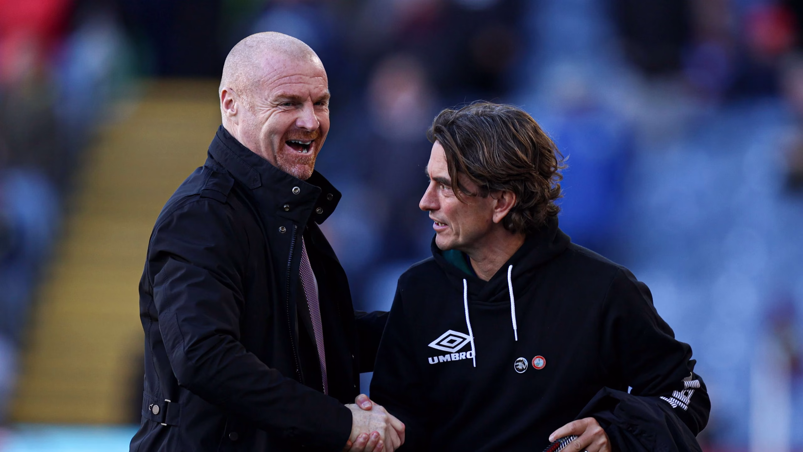 Sean Dyche shaking hands with Brentford manager Thomas Frank on the touchline before a match.
