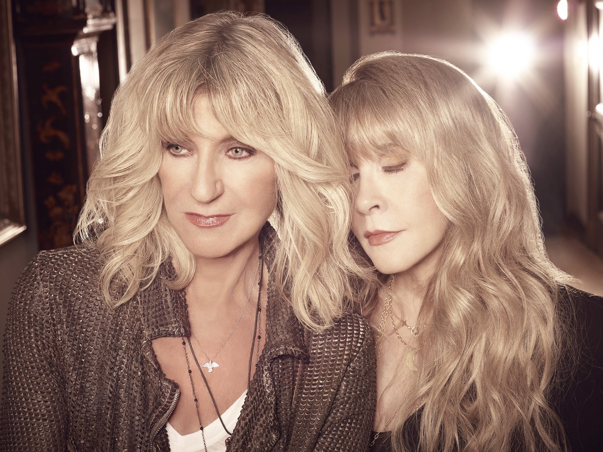 Christine McVie and Stevie Nicks together backstage, showing their close friendship and camaraderie.