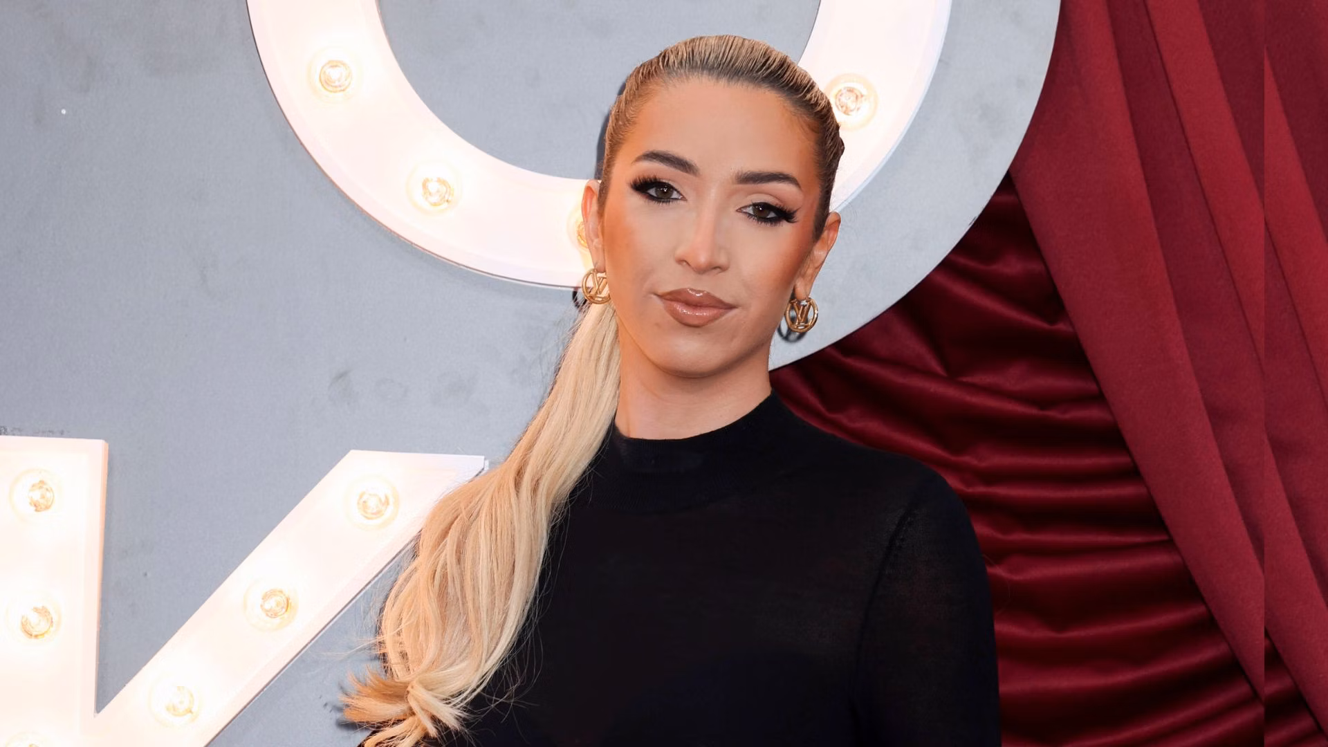 GK Barry at a red-carpet event in London, 2025, British TikTok star and Saving Grace podcast host known for her rapid rise to fame and success.