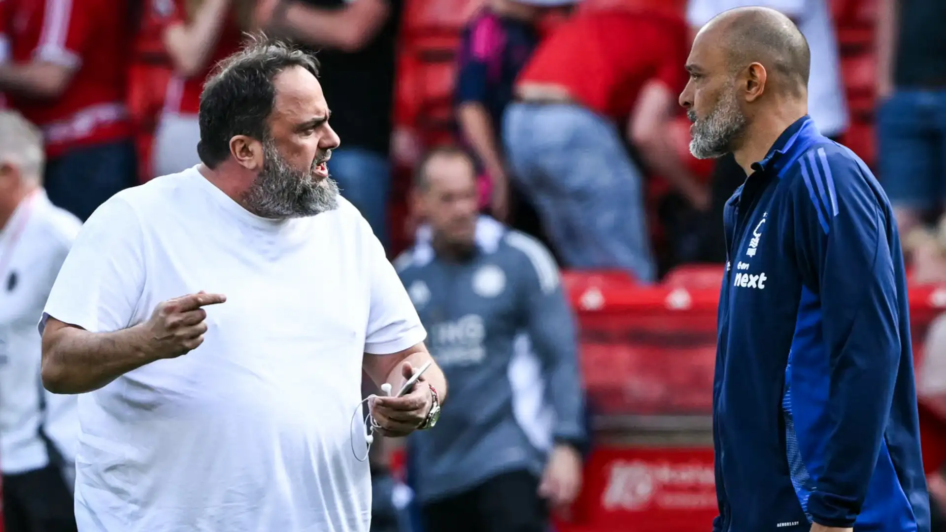 Evangelos Marinakis in a heated discussion with former Nottingham Forest manager Nuno Espírito Santo on the pitch.