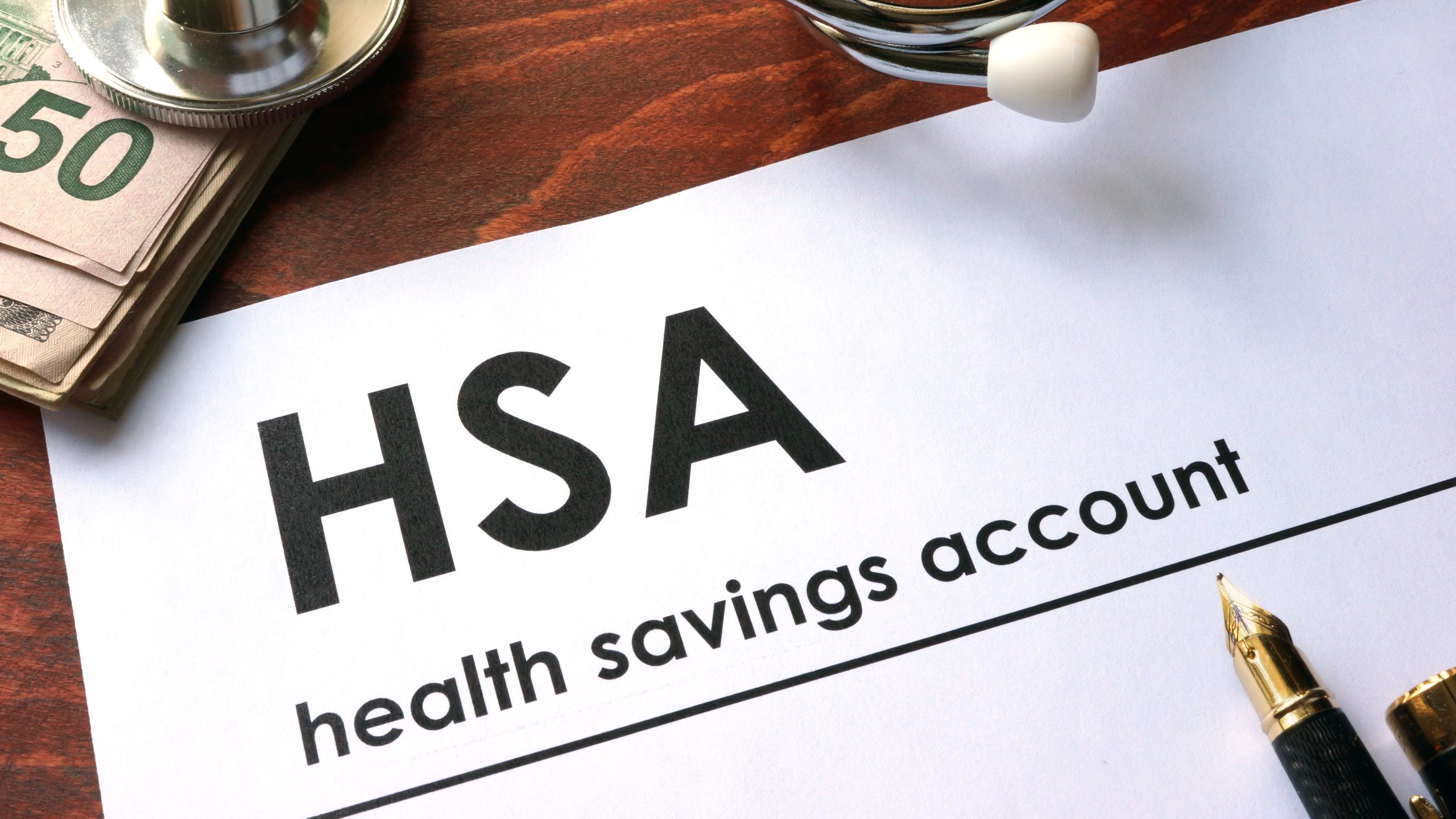 HSA account document on a table with a pen resting on top, ready for contribution or review.