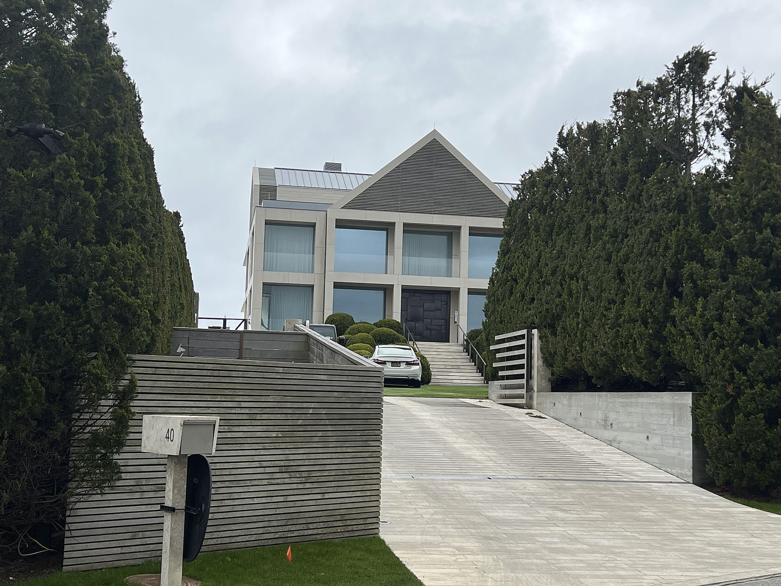 The exterior of Robert Kraft’s Hamptons waterfront mansion, featuring sprawling grounds and luxury architecture.