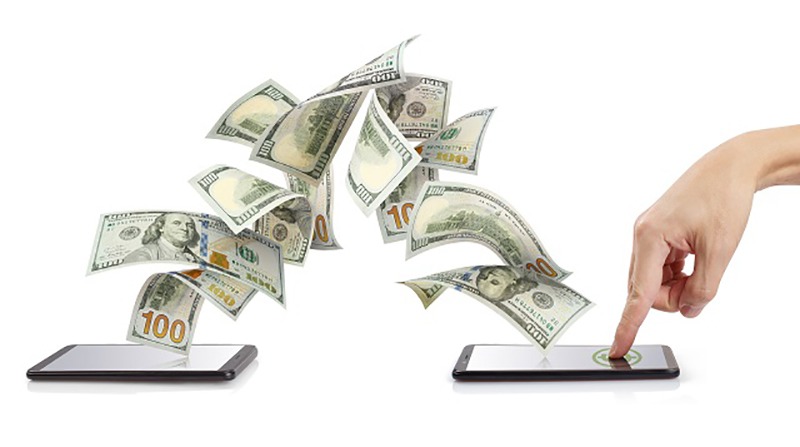Digital device transferring large amounts of cash to another device, symbolizing modern wealth transfer.