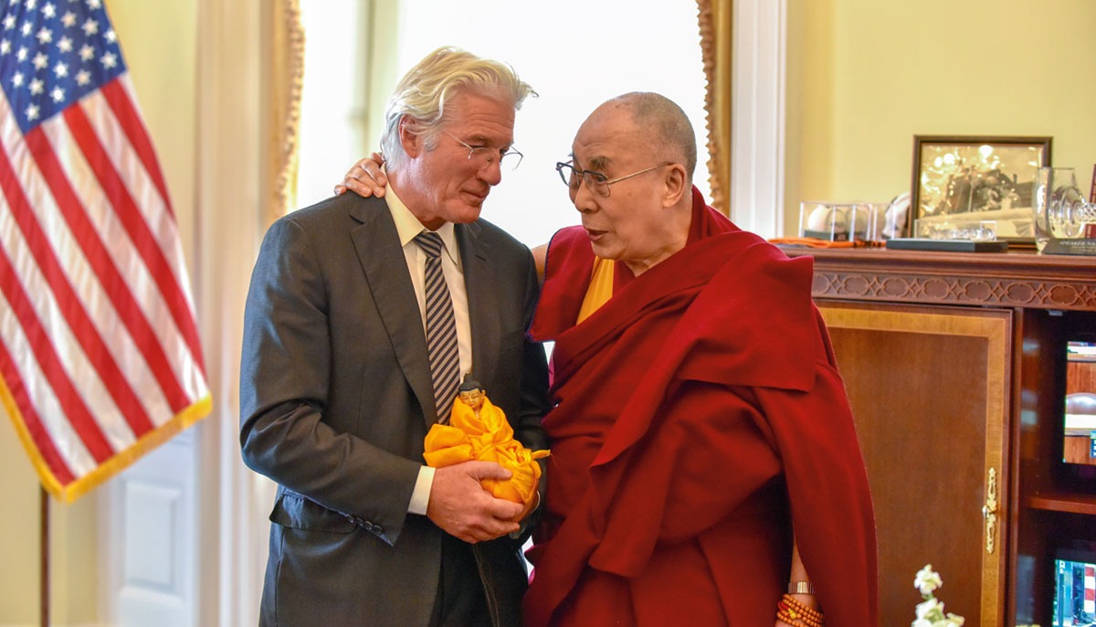 Richard Gere embracing the Dalai Lama during a meeting at the White House.