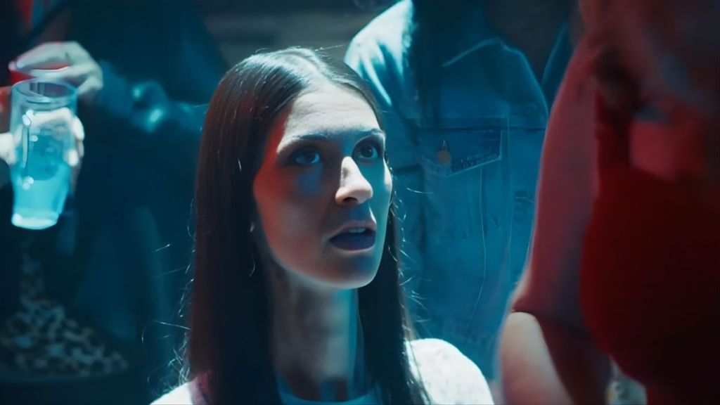 Isabelle Tate in a nightclub scene from 9-1-1: Nashville, portraying her breakout role with vibrant lighting and energetic surroundings.
