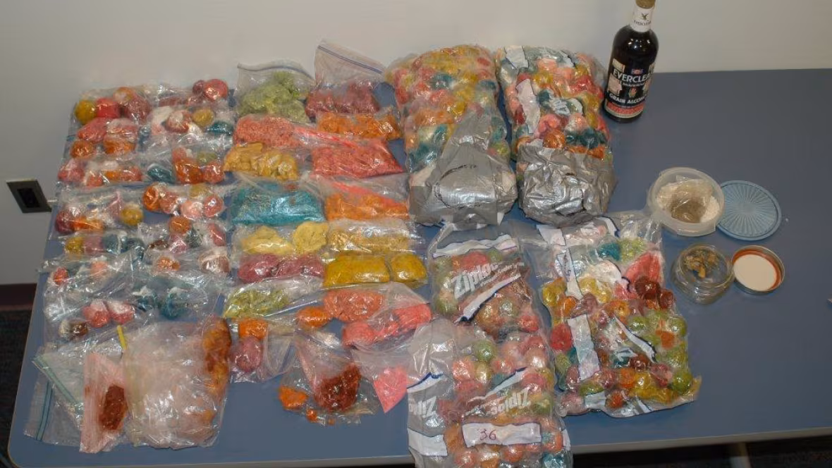 Large bags of seized THC-laced gummies stacked as evidence.