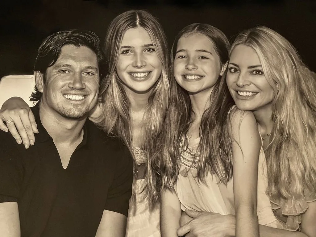 Tess Daly and Vernon Kay smile alongside their two daughters during a relaxed family moment at home.