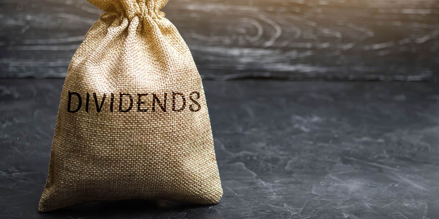 A sack of money labeled "Dividends" overflowing with cash, symbolizing income from dividend-paying stocks.