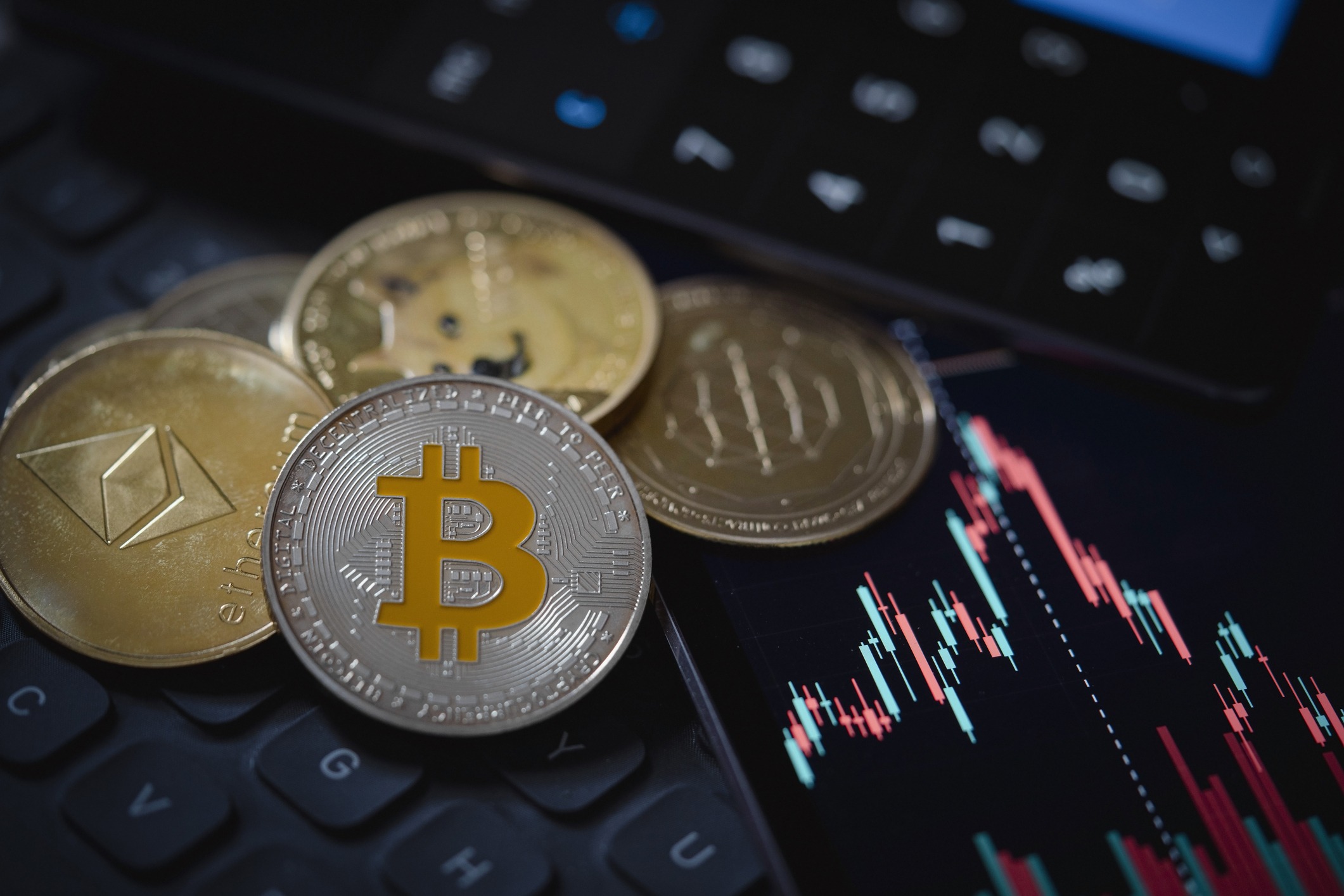bitcoin and ethereum cryptocurrency with candle stick graph chart, laptop keyboard, and digital background