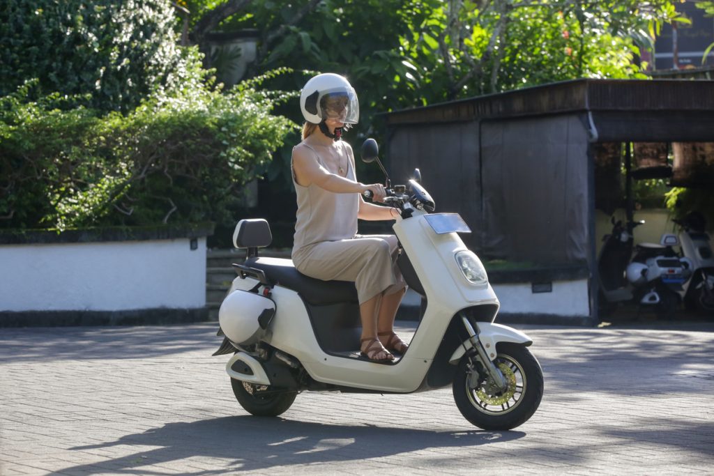 woman tourist riding an electric scooter