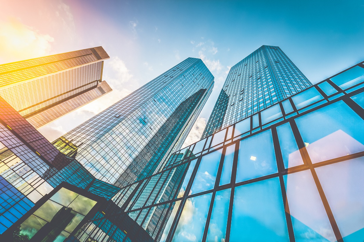 modern skyscrapers in business district at sunset with lens flare effect