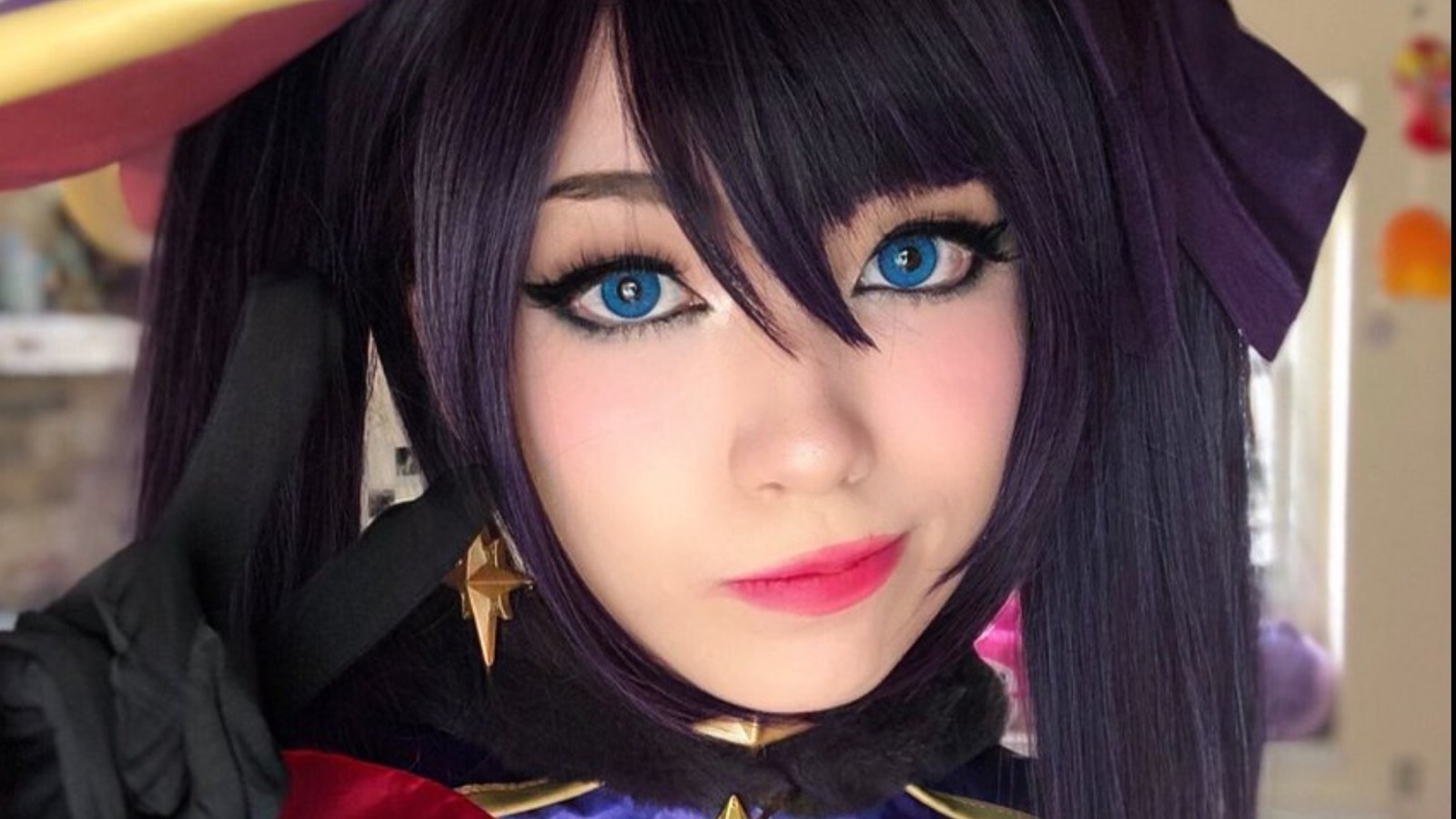 Close-up of Emiru in detailed cosplay, showcasing her expressive makeup and intricate costume design.
