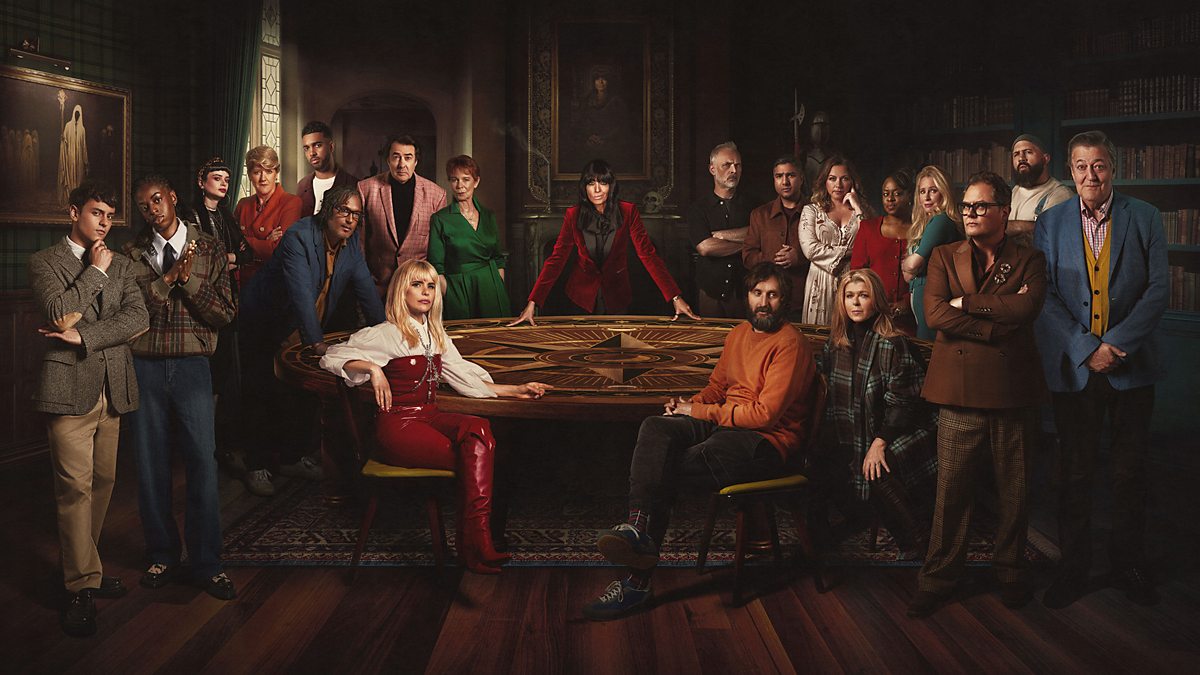"Promotional poster for Celebrity Traitors 2025 featuring host Claudia Winkleman seated at the center of a table surrounded by the 19 celebrity contestants, all dressed in stylish attire, with a dramatic Scottish Highlands backdrop.