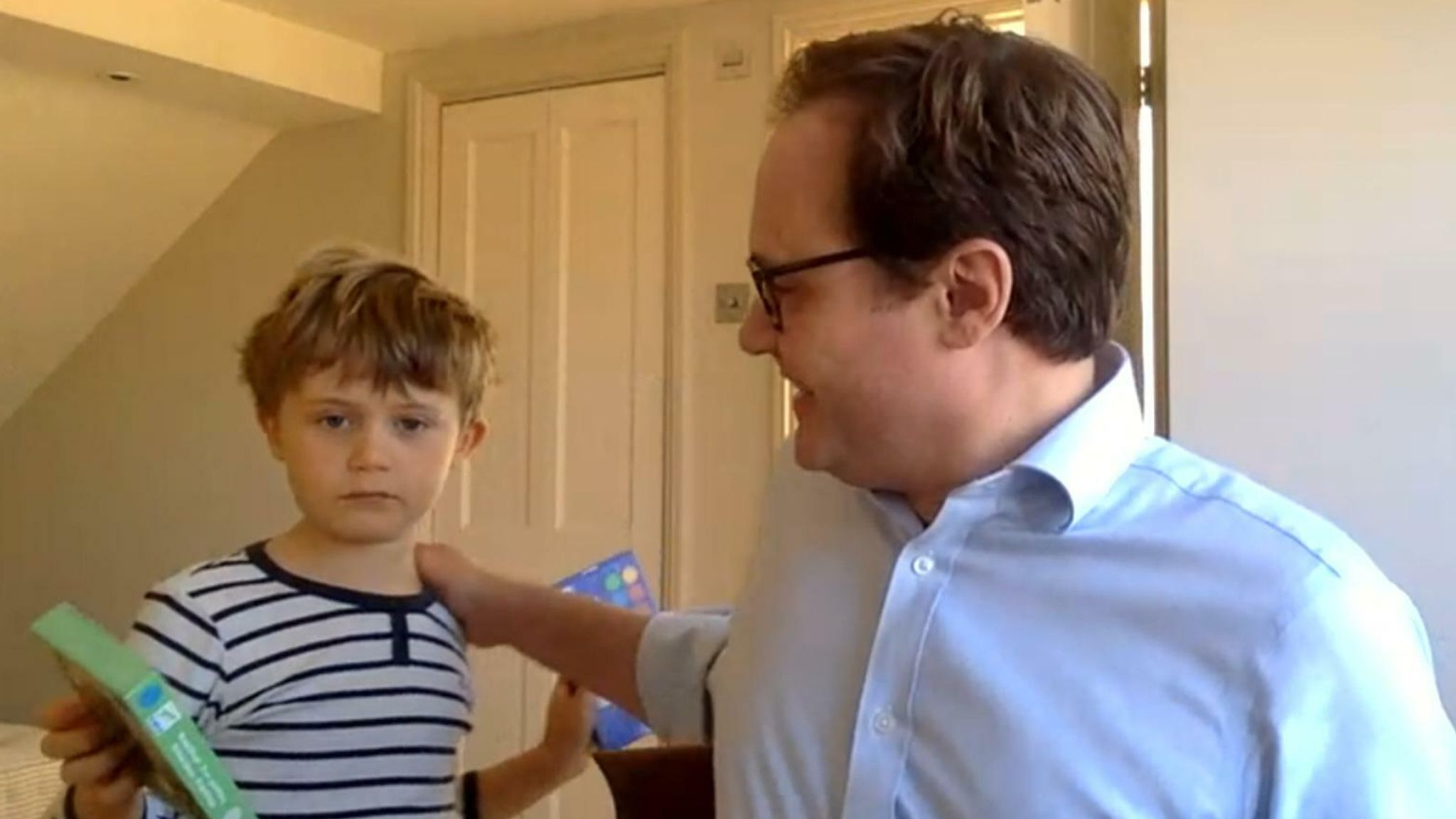 Tom Tugendhat’s son playfully interrupting a live interview, grabbing his father’s attention.